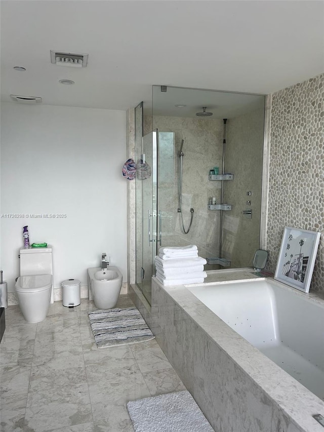 bathroom featuring toilet, a bidet, and independent shower and bath