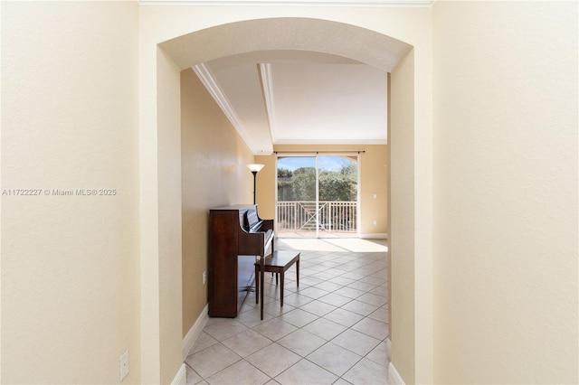 corridor with tile patterned flooring and crown molding