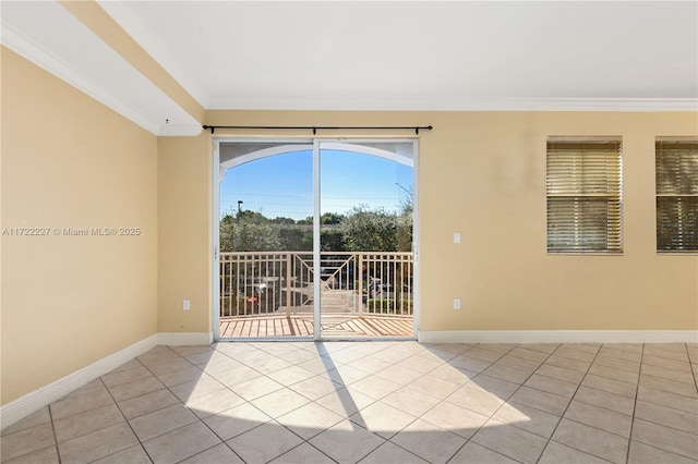 spare room featuring crown molding and light tile patterned floors