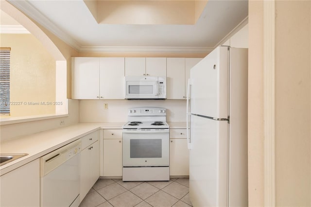 kitchen with white appliances, crown molding, light tile patterned floors, and white cabinets