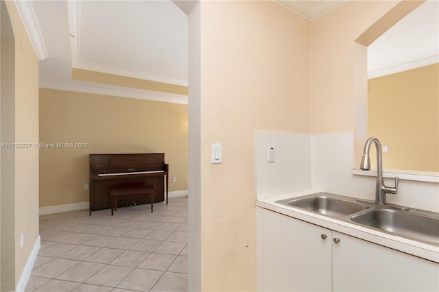 kitchen featuring sink, ornamental molding, and light tile patterned floors