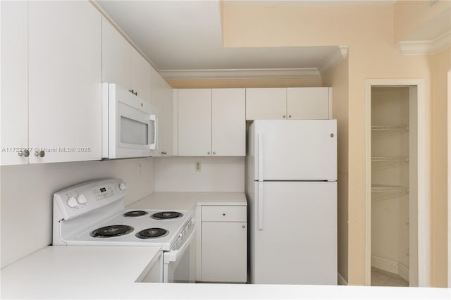 kitchen featuring white appliances, white cabinets, and ornamental molding