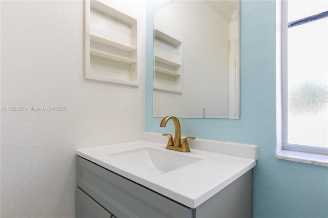 bathroom with built in features and vanity