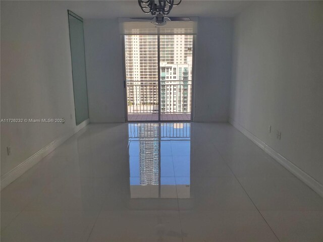 unfurnished room with an inviting chandelier