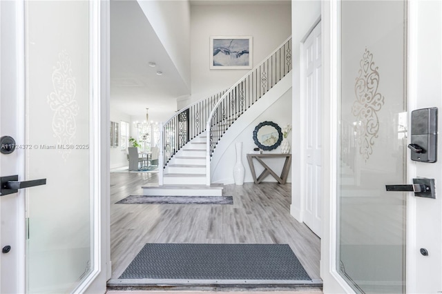 foyer entrance with a chandelier and hardwood / wood-style floors