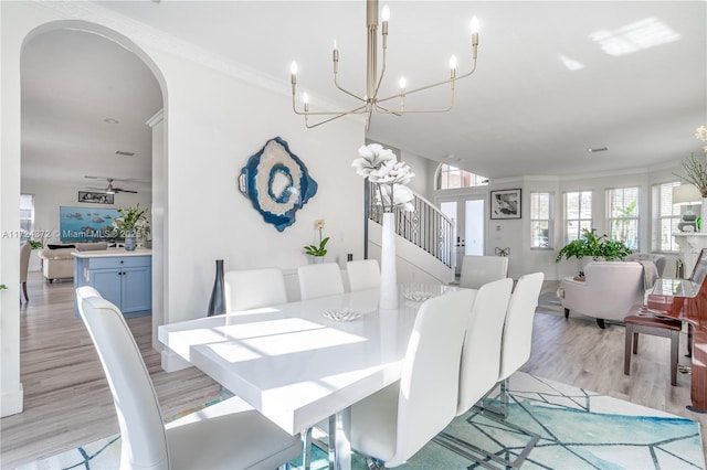 dining space featuring ornamental molding, ceiling fan, and light hardwood / wood-style flooring