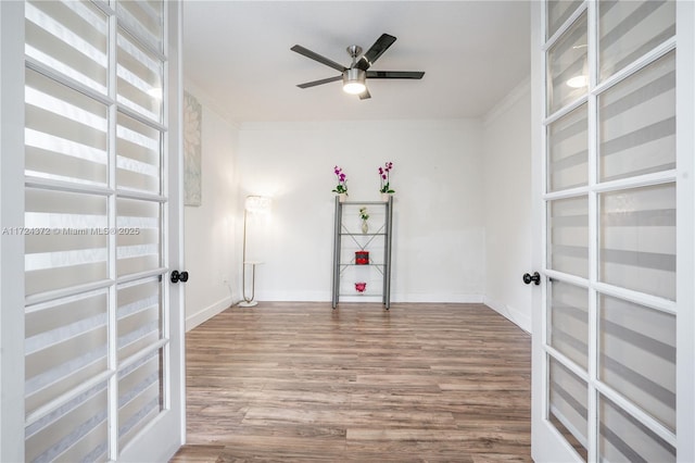 spare room with ornamental molding, ceiling fan, and hardwood / wood-style flooring