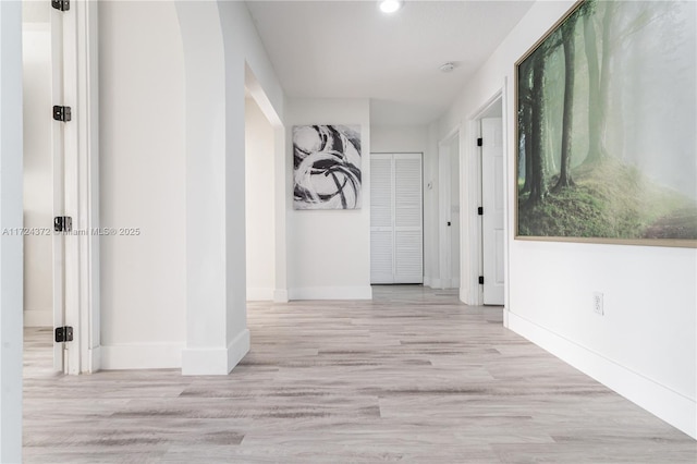 hallway with light hardwood / wood-style flooring