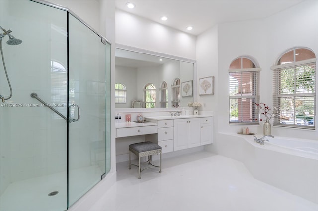 bathroom featuring independent shower and bath and vanity