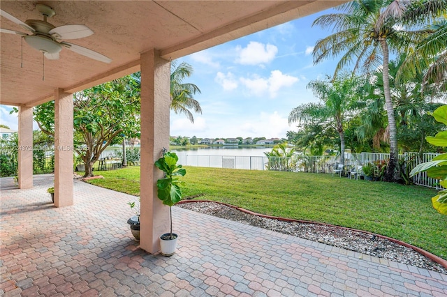 view of patio / terrace featuring ceiling fan and a water view