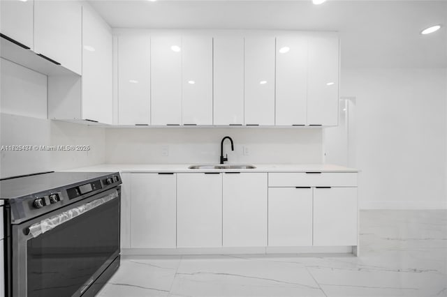 kitchen with sink, white cabinets, and electric stove