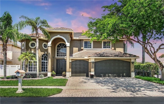 mediterranean / spanish home featuring a garage