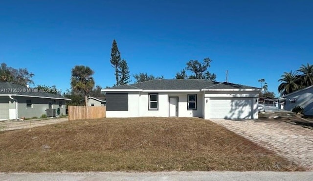 ranch-style house featuring central AC and a garage