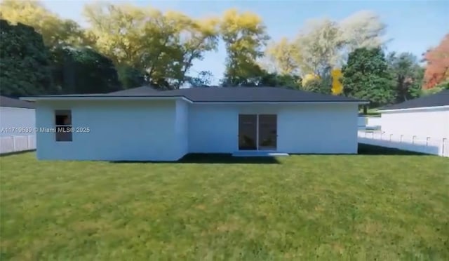 rear view of property featuring a yard