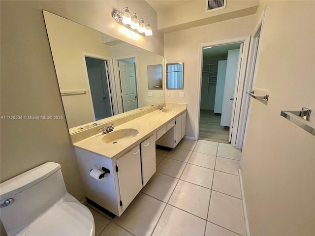 bathroom featuring vanity, tile patterned flooring, and toilet