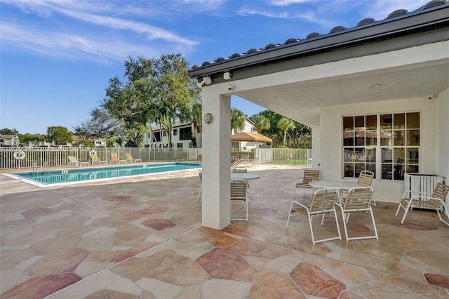 view of patio featuring a community pool