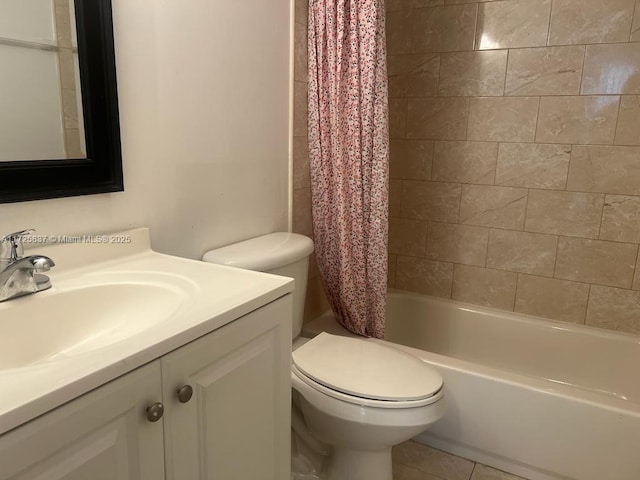 full bathroom featuring toilet, vanity, tile patterned floors, and shower / bath combo with shower curtain