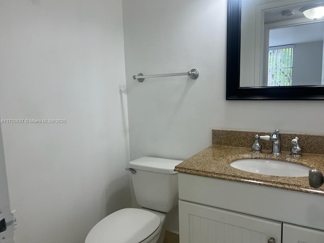 bathroom with toilet and vanity