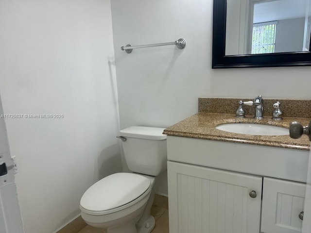 bathroom featuring toilet and vanity