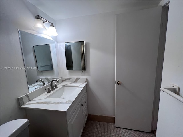 bathroom featuring tile patterned flooring, vanity, and toilet