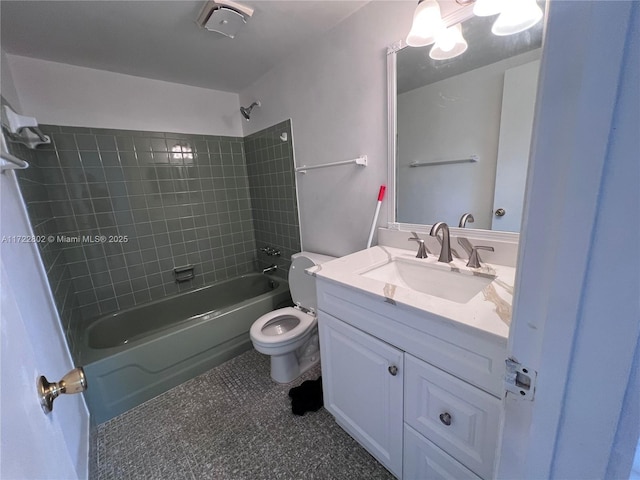 full bathroom featuring toilet, vanity, and tiled shower / bath