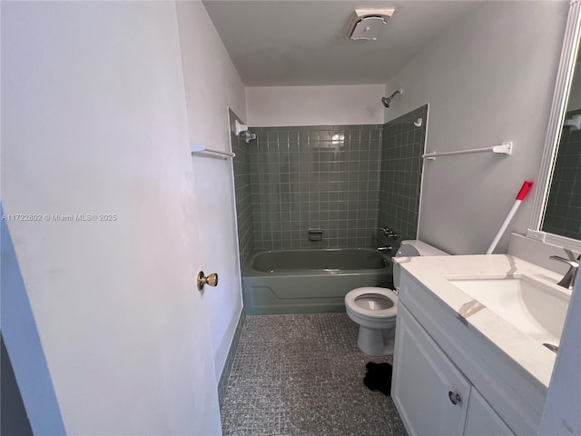 full bathroom featuring tiled shower / bath combo, vanity, and toilet