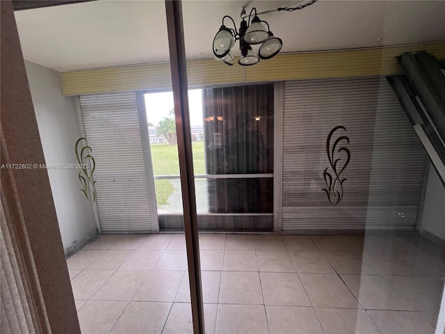 unfurnished sunroom with a notable chandelier