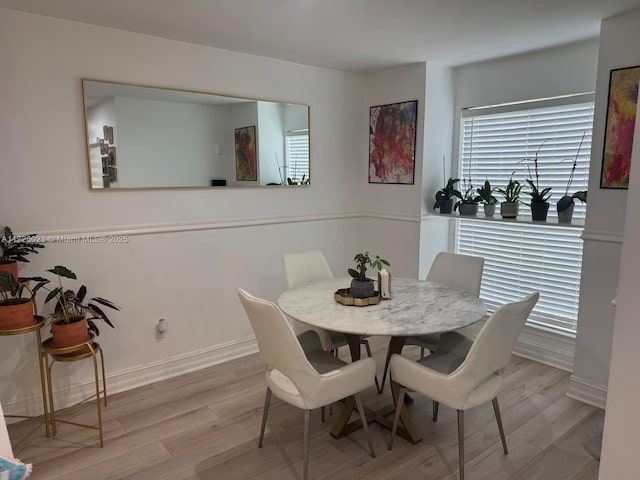 dining area with light hardwood / wood-style floors