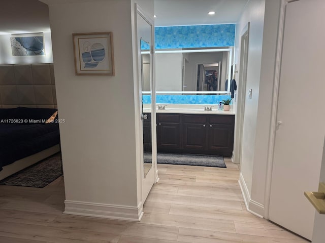 hallway featuring light hardwood / wood-style floors and sink