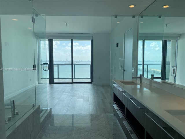 bathroom with vanity, a healthy amount of sunlight, and a water view