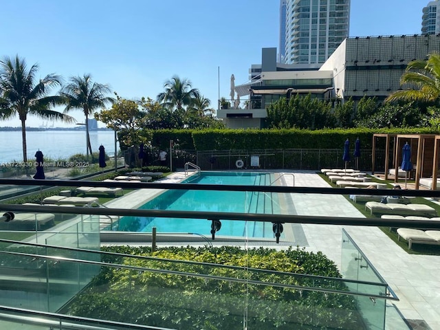 view of swimming pool featuring a water view