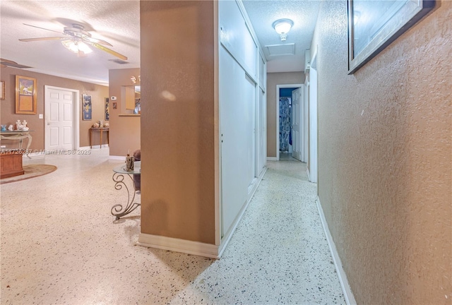 hall featuring a textured ceiling