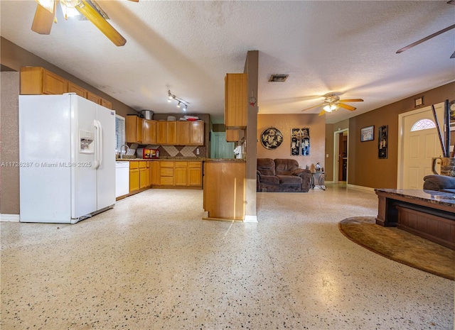 kitchen with a textured ceiling, ceiling fan, sink, and white appliances