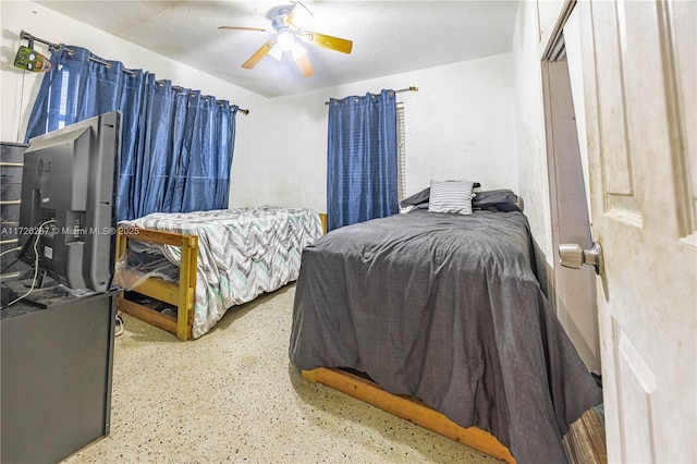 bedroom featuring ceiling fan and a textured ceiling