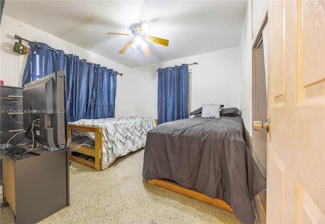 bedroom featuring ceiling fan and a textured ceiling