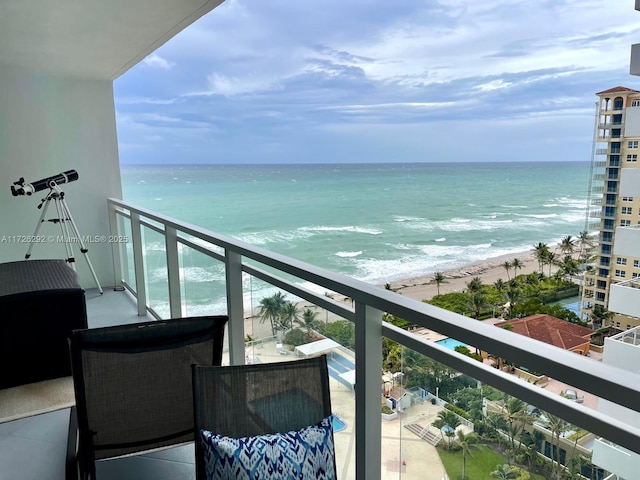 balcony featuring a beach view and a water view