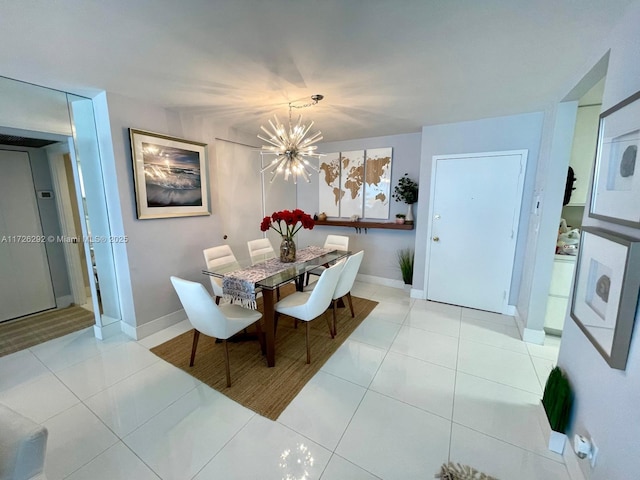 dining room featuring light tile patterned flooring and a chandelier