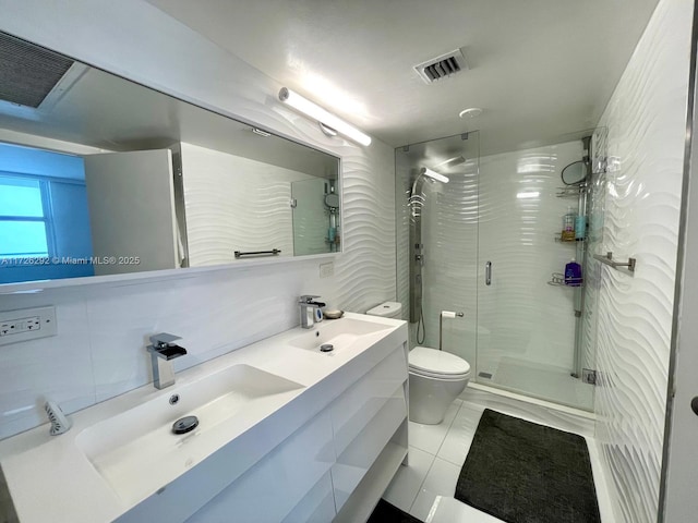 bathroom featuring tile patterned flooring, toilet, walk in shower, vanity, and backsplash