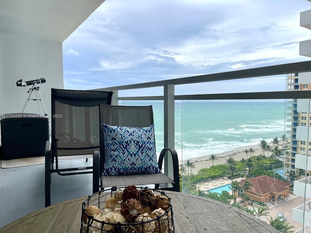 balcony with a beach view and a water view