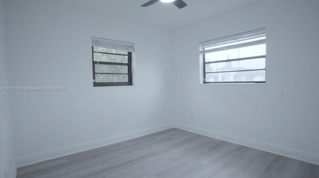 unfurnished room with a healthy amount of sunlight, ceiling fan, and light hardwood / wood-style flooring