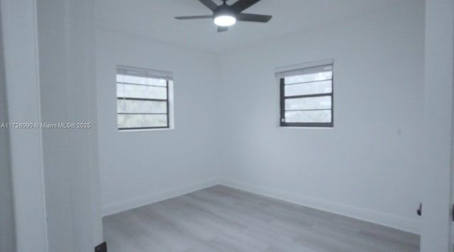 spare room featuring ceiling fan and light hardwood / wood-style floors