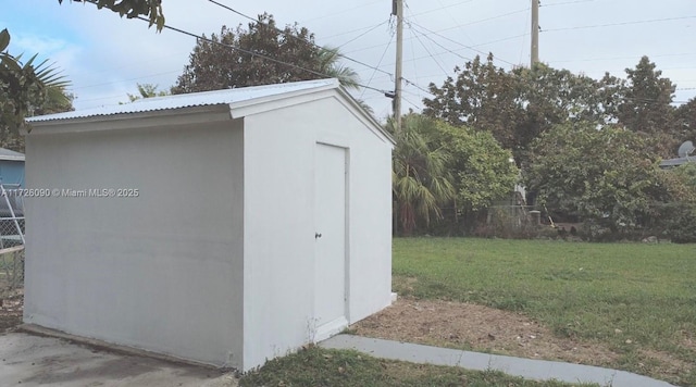 view of outbuilding with a lawn