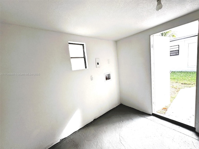 washroom with washer hookup and a textured ceiling