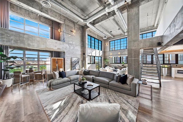 living room with a high ceiling and hardwood / wood-style flooring