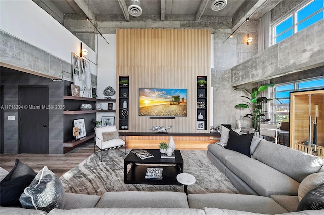 living room featuring a high ceiling and wood-type flooring