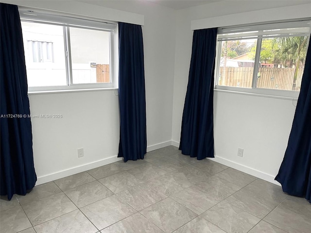 empty room featuring light tile patterned floors