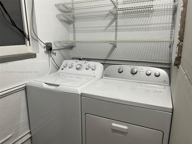 clothes washing area featuring washing machine and clothes dryer