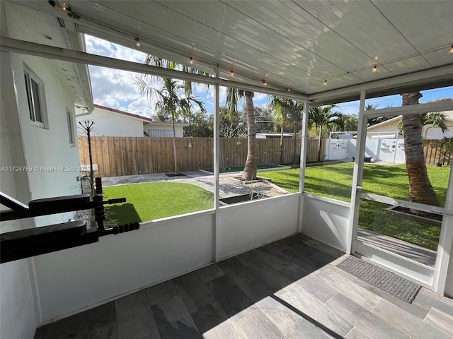 unfurnished sunroom featuring wood ceiling