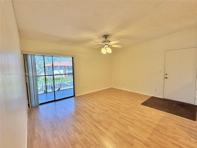 unfurnished room with ceiling fan, light hardwood / wood-style flooring, and a textured ceiling