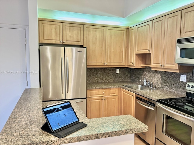 kitchen featuring stainless steel appliances, sink, and backsplash